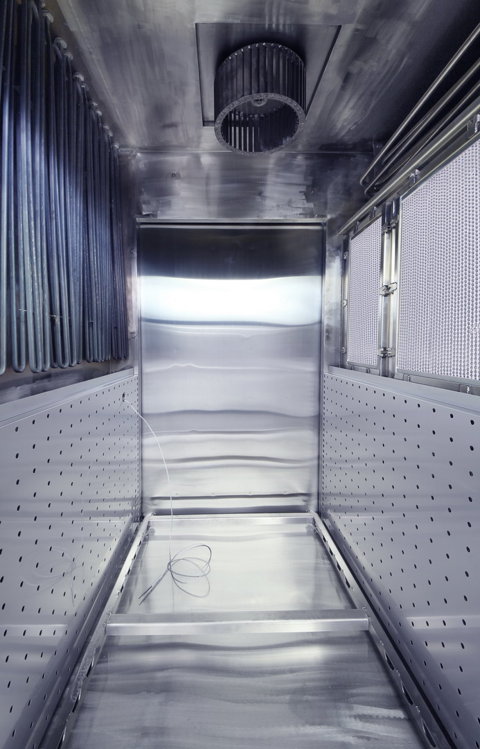 Inner stainless steel chamber of a BMT USA depyrogenation oven with exposed heating elements and HEPA filters in the chamber walls